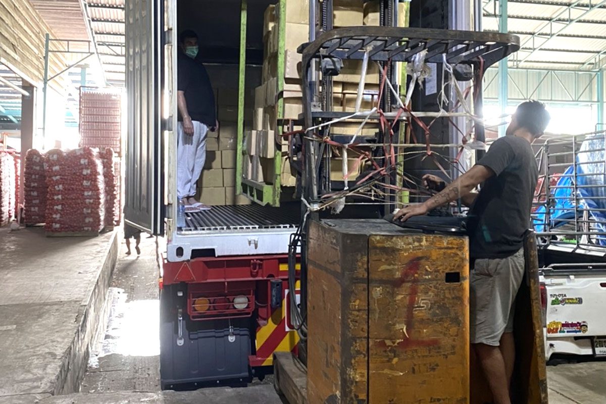 Warehouse team loading a container of goods for export